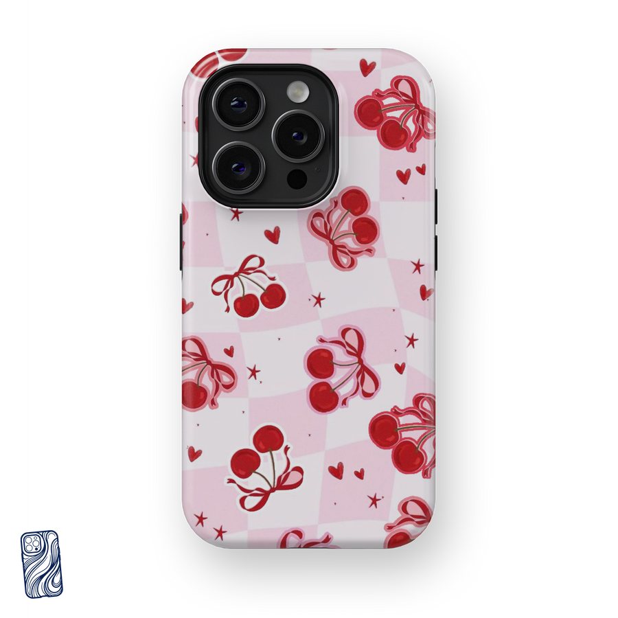 Cherry Kiss Blush Pink premium iPhone case featuring red cherries, bows, hearts and stars over a soft pink checkerboard pattern by CoverShell.
